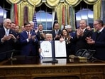 U.S. President Donald Trump poses for a photo after he signs the funding bill to end the U.S. government shutdown, at the White House in Washington, D.C., U.S., November 12, 2025. REUTERS/Kevin Lamarque