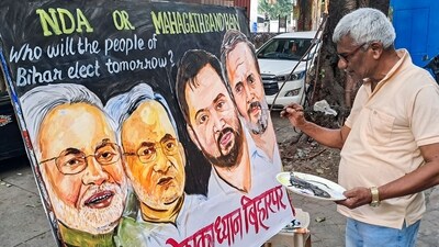 A teacher at Gurukul School of Art creates a painting wishing success to political parties on the eve of the Bihar election results in Mumbai. (ANI)