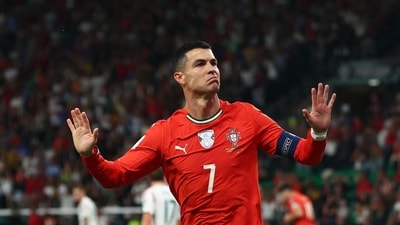 Cristiano Ronaldo gestures to fans as he celebrates a goal for Portugal. (REUTERS)