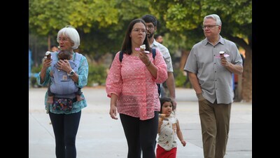 Tourists enjoying ice-cream at the Sector 17 Plaza in Chandigarh on Thursday, which saw the day temperature drop from 28°C on Wednesday to 27°C, normal for this time of the year. (Keshav Singh/HT)