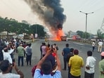Smoke billows as fire engulfs two large container trucks and a car after an accident on a bridge along the Mumbai-Bengaluru Highway.