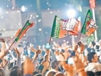 Supporters outside BJP headquarters after the victory on Friday. (Sanchit Khanna/HT Photo)