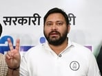 RJD leader Tejashwi Yadav with party leaders flashing victory sign during a press conference at his residence, Polo road in Patna, Bihar.