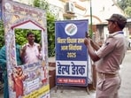 Security personnel take photo of a voter at a polling station during the first phase of Bihar Elections 2025, in Vaishali.