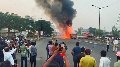 Smoke billows as fire engulfs two large container trucks and a car after an accident on a bridge along the Mumbai-Bengaluru Highway. (PTI) Smoke billows as fire engulfs two large container trucks and a car after an accident on a bridge along the Mumbai-Bengaluru Highway. (PTI)