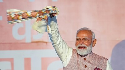 Prime Minister Narendra Modi waves a "gamchha", a traditional scarf, during the celebration of NDA's victory in the Bihar assembly elections, at BJP headquarters in New Delhi on Friday, November 14, 2025. (Karma Bhutia/PTI Photo) Prime Minister Narendra Modi waves a "gamchha", a traditional scarf, during the celebration of NDA's victory in the Bihar assembly elections, at BJP headquarters in New Delhi on Friday, November 14, 2025. (Karma Bhutia/PTI Photo)