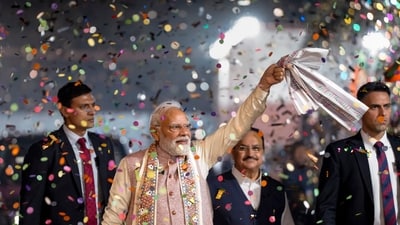 Prime Minister Narendra Modi waves a gamcha as he arrives during the celebration of NDA's victory in the Bihar Assembly elections, at BJP headquarters, in New Delhi, Friday, (PTI) Prime Minister Narendra Modi waves a gamcha as he arrives during the celebration of NDA's victory in the Bihar Assembly elections, at BJP headquarters, in New Delhi, Friday, (PTI)