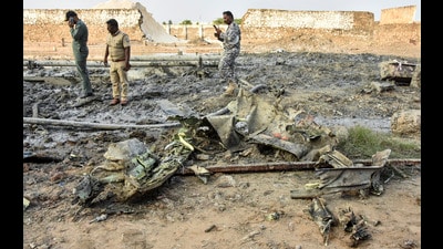 Police and Indian Air Force (IAF) personnel stand amid charred debris after an IAF aircraft which was on a routine training mission, crashed near Tambaram, in Chengalpattu district, Tamil Nadu on Friday. (PTI PHOTO) Police and Indian Air Force (IAF) personnel stand amid charred debris after an IAF aircraft which was on a routine training mission, crashed near Tambaram, in Chengalpattu district, Tamil Nadu on Friday. (PTI PHOTO)