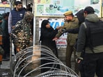 A woman being stoped by police near the Nowgam police station on Saturday. (Waseem Andrabi /HT) A woman being stoped by police near the Nowgam police station on Saturday. (Waseem Andrabi /HT)