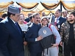 Himachal CM Sukhvinder Singh Sukhu handing over school bag to a student during an event on The Ridge on Friday. (Deepak Sansta/HT)