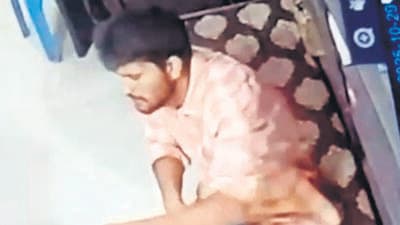 A screengrab from a CCTV footage showing Nabi getting a mobile phone repaired. A screengrab from a CCTV footage showing Nabi getting a mobile phone repaired.