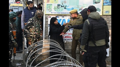 A woman being stoped by police near the Nowgam police station on Saturday. (Waseem Andrabi /HT) A woman being stoped by police near the Nowgam police station on Saturday. (Waseem Andrabi /HT)