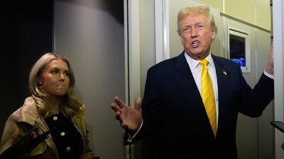 President Donald Trump speaks to reporters on Air Force One on his way to his Mar-a-Lago estate in Palm Beach, Fla., Friday, Nov. 14, 2025, as White House press secretary Karoline Leavitt listens. (AP) President Donald Trump speaks to reporters on Air Force One on his way to his Mar-a-Lago estate in Palm Beach, Fla., Friday, Nov. 14, 2025, as White House press secretary Karoline Leavitt listens. (AP)