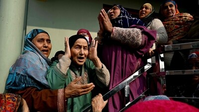Relatives of the victims who died in an accidental blast at Nowgam police station, mourn in their house on the outskirts of Srinagar. (AFP)