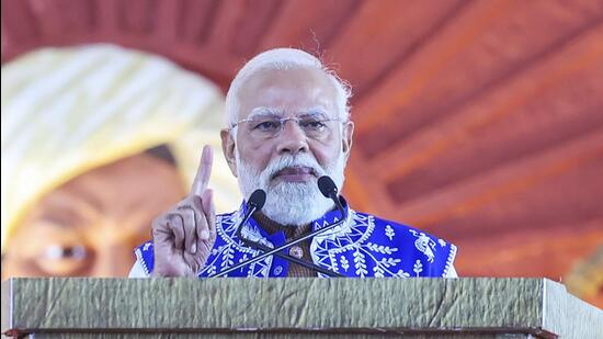 Prime Minister Narendra Modi addressing a gathering after inaugurating and laying the foundation stone of development projects worth over ₹9,700 crore in the tribal belt of south Gujarat. (PMO)