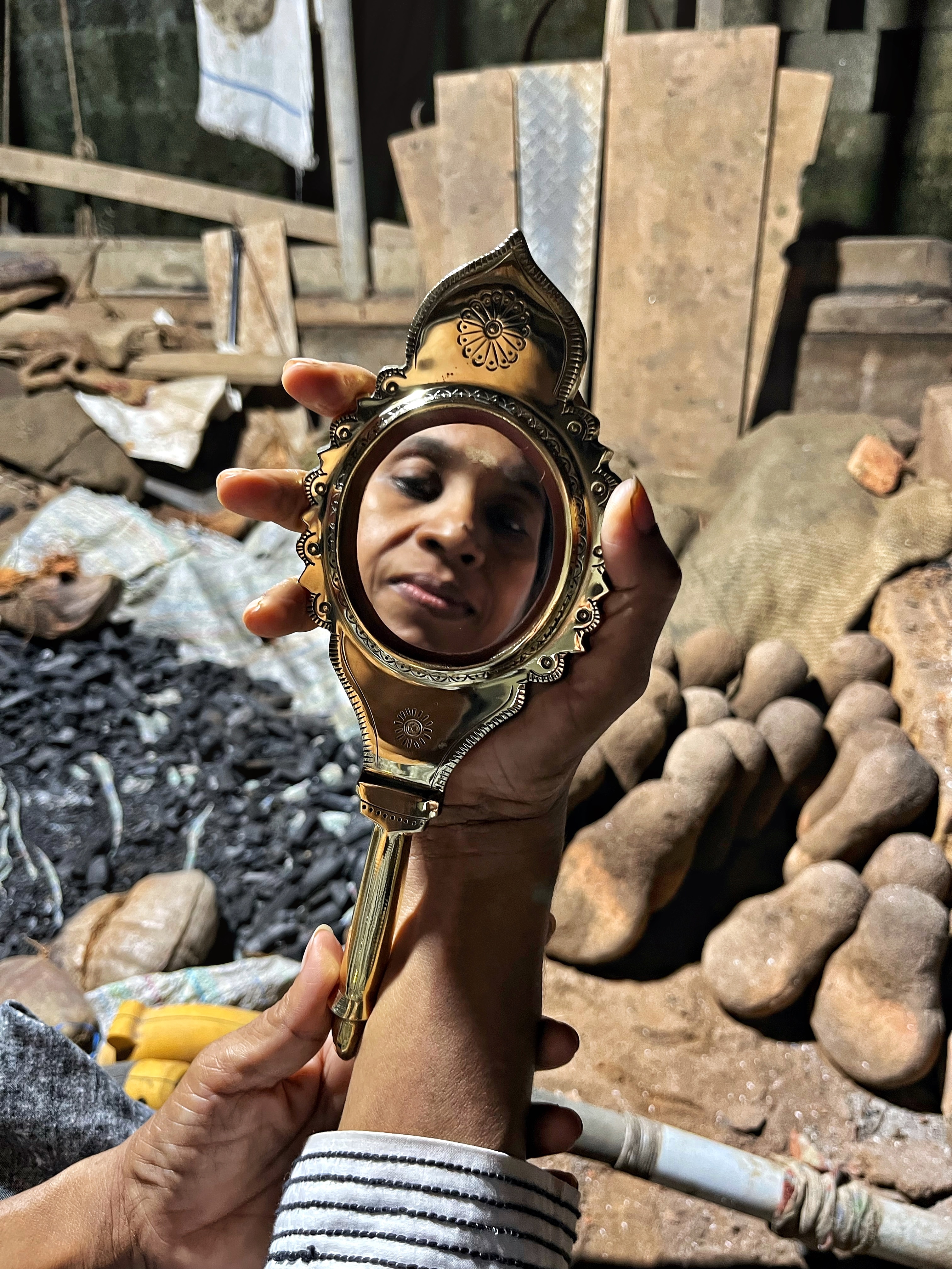 J Sudhammal poses with one of her metal mirrors. (Eliot Stein) J Sudhammal poses with one of her metal mirrors. (Eliot Stein)