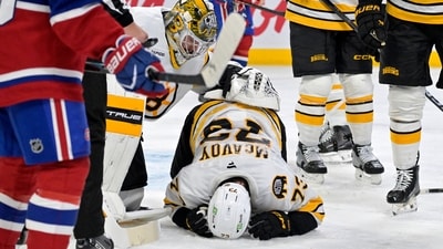 Nov 15, 2025; Montreal, Quebec, CAN; Boston Bruins goalie Jeremy Swayman (1) checks on teammate Boston Bruins defenseman Charlie McAvoy (73) who got hit by a shot in the face during the second period of the game against the Montreal Canadiens at the Bell Centre. (IMAGN IMAGES via Reuters Connect)