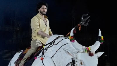 Mahesh Babu rides a mechanical bull at the unveiling of the first look of the film Varanasi in Hyderabad. (AP) Mahesh Babu rides a mechanical bull at the unveiling of the first look of the film Varanasi in Hyderabad. (AP)