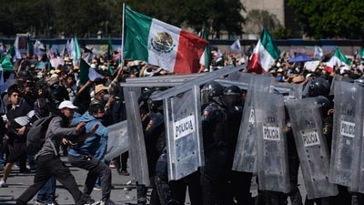 Protesters charge against police during a youth anti-government march in Mexico City on Saturday. (AP) Protesters charge against police during a youth anti-government march in Mexico City on Saturday. (AP)
