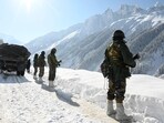 (FILES) Indian army soldiers walk along a road near Zojila mountain pass that connects Srinagar to the union territory of Ladakh, bordering China on February 28, 2021. (Photo by TAUSEEF MUSTAFA / AFP) (AFP) (FILES) Indian army soldiers walk along a road near Zojila mountain pass that connects Srinagar to the union territory of Ladakh, bordering China on February 28, 2021. (Photo by TAUSEEF MUSTAFA / AFP) (AFP)