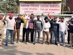 Contractual workers of Punjab Roadways, Punbus and PRTC staging a protest at the Ludhiana bus stand on Monday. (Manish/HT)