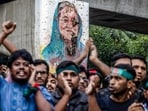 Students chant slogans near a vandalised mural of Bangladesh's ousted Prime Minister Sheikh Hasina, during a protest demanding accountability and trial against Hasina, near Dhaka University in the capital on August 12, 2024.