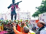 Uttar Pradesh chief minister Yogi Adityanath pays floral tribute to the newly unveiled statue of Veerangana Uda Devi Pasi, in Lucknow on Sunday. Union Defence Minister Rajnath Singh also present. (@myogiadityanath X/ANI)