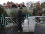 A man fills a water tank in Tehran, Nov. 14.