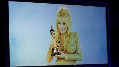 Dolly Parton appears on screen as she is honoured with the Jean Hersholt Humanitarian Award during the Academy of Motion Picture Arts and Sciences 16th Governors Awards in Los Angeles, California, U.S., November 16, 2025. REUTERS/Mario Anzuoni (REUTERS)