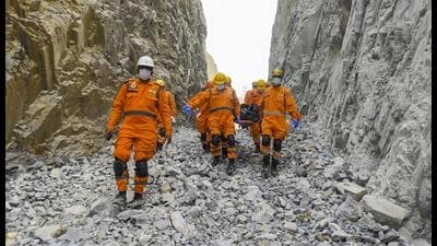 NDRF personnel conduct a rescue operation on Monday after a portion of a stone quarry collapsed in Sonbhadra. (PTI Photo) NDRF personnel conduct a rescue operation on Monday after a portion of a stone quarry collapsed in Sonbhadra. (PTI Photo)