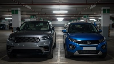 A Range Rover and Tata Nexon in an underground parking lot. (AI Image) A Range Rover and Tata Nexon in an underground parking lot. (AI Image)