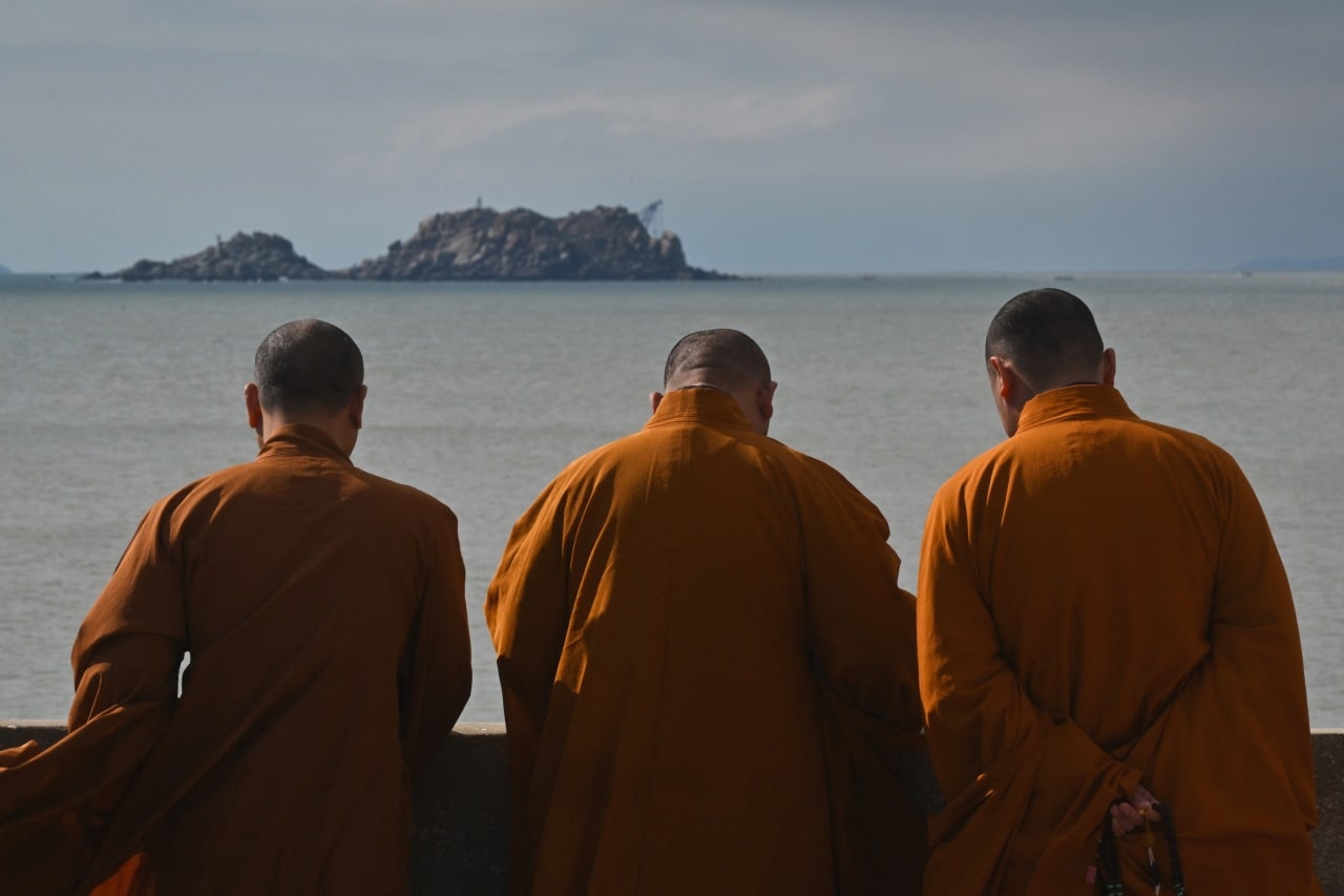 Monks look over the sea on Pingtan Island, the closest point in China to Taiwan's main island. Monks look over the sea on Pingtan Island, the closest point in China to Taiwan's main island.