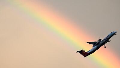A SpiceJet aircraft flies past a rainbow in Chennai. (AFP)