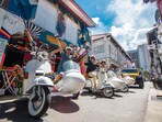 Experience a vintage sidecar ride through vibrant neighborhoods, passing iconic spots like Geylang and Chinatown.