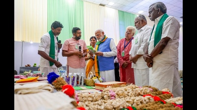 Prime Minister Narendra Modi visits a stall and interacts with farmers during the inauguration of an exhibition as part of the South India Natural Farming Summit-2025, in Coimbatore, Tamil Nadu. (PMO)