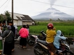Local residents gather as Mount Semeru volcano spews volcanic ash during an eruption in Supiturang village in Lumajang, East Java province, Indonesia.