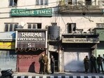 Police personnel outside the Kashmir Times office during a raid by the state investigation agency (SIA) on Thursday. (PTI Photo)
