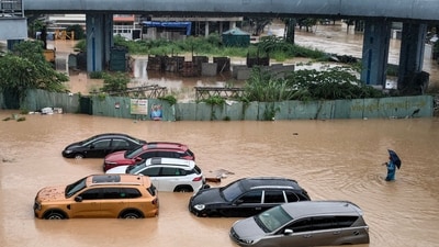 A man wades through floodwaters near inundated vehicles in Nha Trang, Vietnam's coastal province of Khanh Hoa on November 20, 2025. (Photo by AFP) (AFP) A man wades through floodwaters near inundated vehicles in Nha Trang, Vietnam's coastal province of Khanh Hoa on November 20, 2025. (Photo by AFP) (AFP)