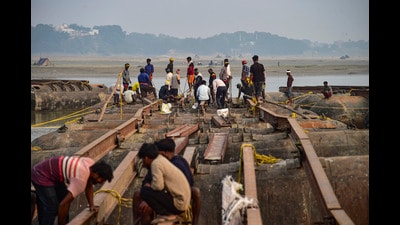 Workers construct a pontoon bridge amid preparations for the 'Magh Mela 2026', in Prayagraj on Thursday. (PTI) Workers construct a pontoon bridge amid preparations for the 'Magh Mela 2026', in Prayagraj on Thursday. (PTI)