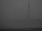 Men walk on the Yamuna riverbed amid heavy smog in New Delhi.