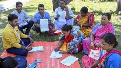 A booth level officer oversees the filling of enumeration forms by voters for the special intensive revision of electoral rolls, in Malda district of West Bengal on November 18. (PTI) A booth level officer oversees the filling of enumeration forms by voters for the special intensive revision of electoral rolls, in Malda district of West Bengal on November 18. (PTI)