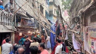 Residents stand in an alley after vacating their house next to a fallen scaffolding following an earthquake in Dhaka. (REUTERS)