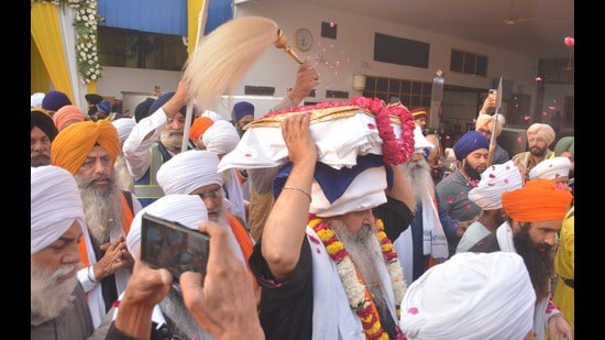 A Sikh priest carries the Guru Granth Sahib during a nagar kirtan organised by the Punjab government to commemorate the martyrdom anniversary of Guru Teg Bahadur, in Amritsar on Friday. (Sameer Sehgal/Hindustan Times)