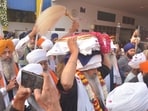 A Sikh priest carries the Guru Granth Sahib during a nagar kirtan organised by the Punjab government to commemorate the martyrdom anniversary of Guru Teg Bahadur, in Amritsar on Friday. (Sameer Sehgal/Hindustan Times) A Sikh priest carries the Guru Granth Sahib during a nagar kirtan organised by the Punjab government to commemorate the martyrdom anniversary of Guru Teg Bahadur, in Amritsar on Friday. (Sameer Sehgal/Hindustan Times)