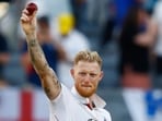 Ben Stokes raises the ball after taking five wickets during the first Ashes match.