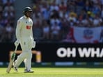 Usman Khawaja looks dejected and walks back to the pavilion after losing his wicket.