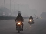 Commuters are seen amid a thick layer of haze at Sector 37C road in Gurugram. (Parveen Kumar/HT) Commuters are seen amid a thick layer of haze at Sector 37C road in Gurugram. (Parveen Kumar/HT)