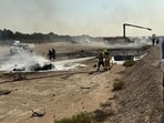 Firefighters work at the site of a crash involving an Indian-made HAL Tejas fighter jet at the Dubai Airshow.