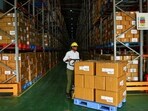 FILE PHOTO: A labourer uses a pallet truck to shift boxes at the Jan Aushadhi Central Warehouse during an organized media tour,