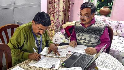 A booth level officer in Bikaner assists a voter in filling out the enumeration form for the SIR of the state’s voter list (PTI FILE PHOTO/Representative Image) A booth level officer in Bikaner assists a voter in filling out the enumeration form for the SIR of the state’s voter list (PTI FILE PHOTO/Representative Image)